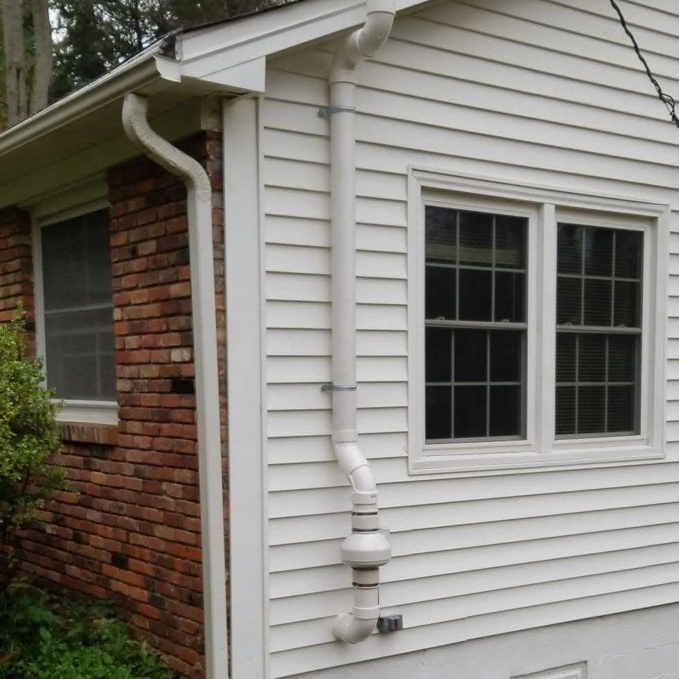 Radon Mitigation System Installed on North Carolina Home Exterior
