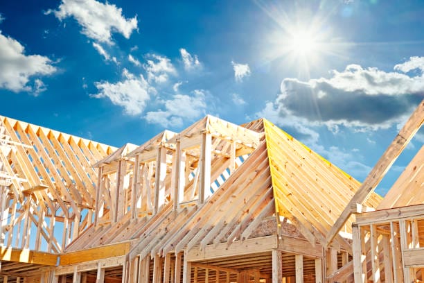 New Construction Mitigation with Wooden Roof Frame under Blue Sky
