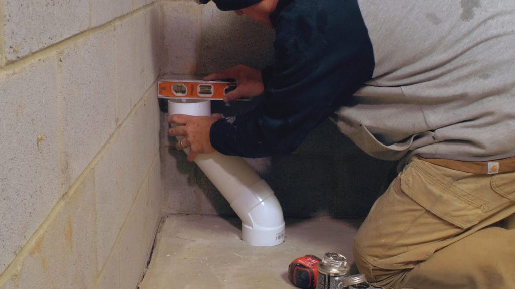 Radon system pipe being measured 